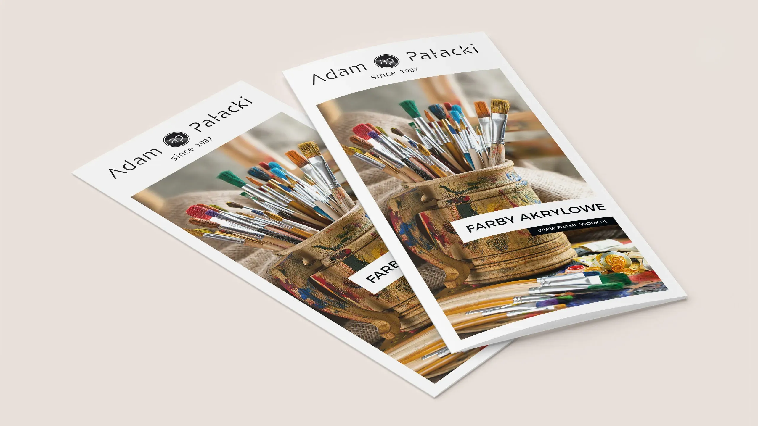 Ulotka reklamowa Framework z serii farb akrylowych Adam Palacki z fotografią pędzli malarskich w drewnianym pojemniku.