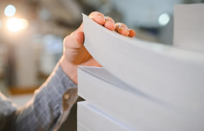 kontrola jakości papieru w druku arkusze papieru w dłoni